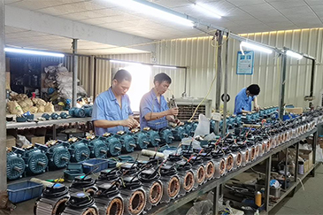 Workers assembling fan motors in the manufacturer's workshop